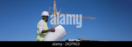 African American architect compares building to drawings Stock Photo