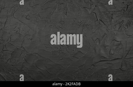 Black uneven grunge surface abstract background Stock Photo
