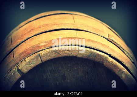 Wooden barrel on a background of black texture Stock Photo