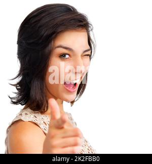 Heres looking at you kid. Pretty young woman pointing at the camera and winking, isolated on white - copyspace. Stock Photo