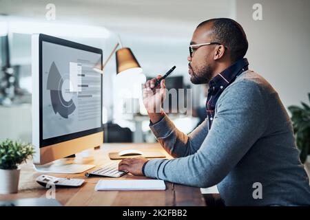 Thinking of the next step forward. Shot of a handsome young businessman in deep thought while working in his office. Stock Photo