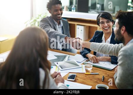 Its great to have you on board. Cropped shot of two businessmen shaking hands during a meeting. Stock Photo