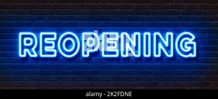 Neon sign on a brick wall - Reopening Stock Photo