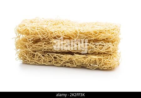 Instant noodles. Uncooked chinese noodles isolated on white background. Stock Photo