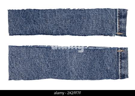 Closeup of two cut-off pant leg pieces of a blue denim jeans isolated on white background. Macro. Stock Photo