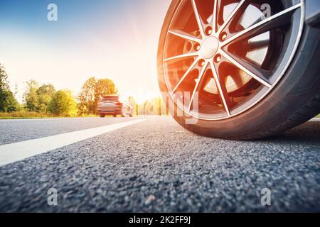 Close-up view of the car's wheel on the highway. Stock Photo