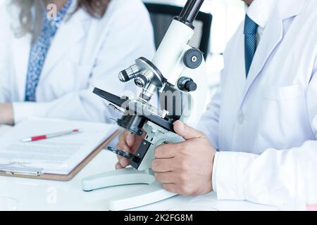 Scientists are researching and recording in science laboratories. Stock Photo