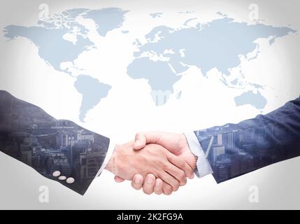 Business people shake hands with a map in the background,Agreement, cooperation,Closeup Stock Photo