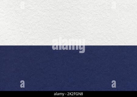 Texture of craft white and navy blue paper background, half two colors, macro. Structure of vintage dense denim cardboard. Felt backdrop closeup. Stock Photo