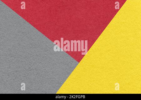 Texture of craft gray, red and yellow shade color paper background, macro. Structure of vintage abstract cardboard with geometric shape and gradient. Stock Photo