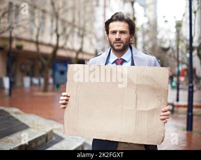 Got work. Standing unemployed businessman looking for work. Stock Photo