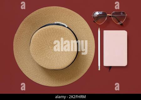 Female summer clothes and accessories flat lay. Hardcover textbook mockup. Stock Photo