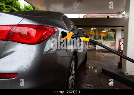 Car refueling fuel on petrol station. Service is filling gas or biodiesel into the tank. Automotive industry or transportation concept Stock Photo