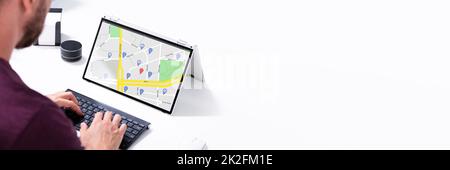 Man Browsing GPS Map On Laptop Stock Photo