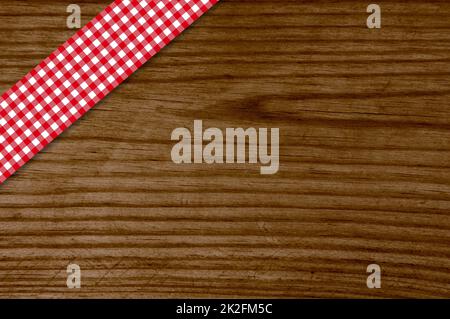 Red tablecloth stripe on old wooden board Stock Photo
