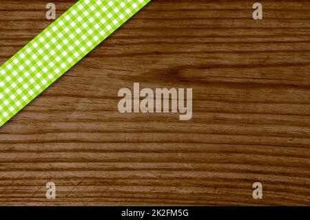 Green tablecloth stripe on old wooden board Stock Photo