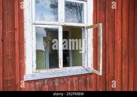 Open window on an old abandoned cottage Stock Photo