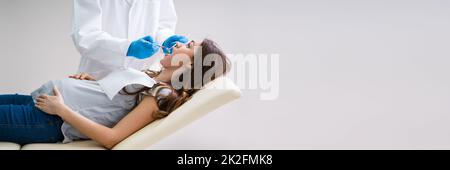 Pregnant Woman Having Teeth Examined At Dentists Stock Photo