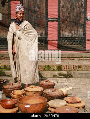 Nepal. 23rd Sep, 2022. A young boy from Raute community stands next to the handmade wooden utensils in 'The Raute Exhibition' program held at Bhaktapur Durbar Square on Friday.The last nomadic ethnic group of Nepal, Raute are known for living in forest and hunting monkeys. They are one of the endangered community of South Asia. They live in temporary tents in remote parts of the forest. While they have a talent for crafting wood and creating striking household utensils, they use it to barter for food-grains with the local people. At present, government provides them certain amount as soci Stock Photo