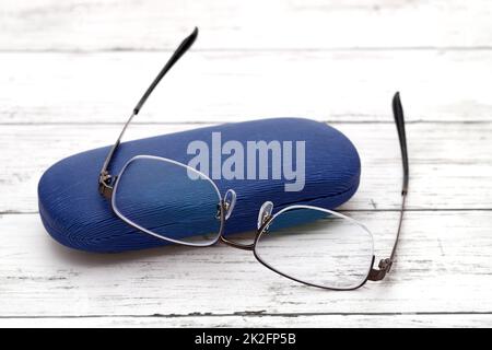 Stylish eyesight glasses and case for glasses on white wooden table Stock Photo