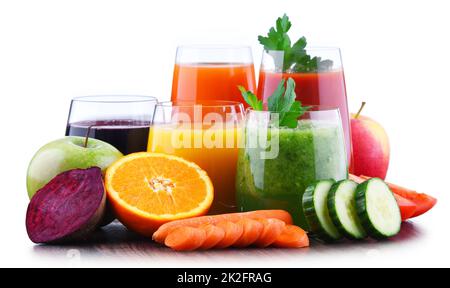 Isolated juices. Glasses of fresh juice and pile of tropical fruits  isolated on white background with clipping path Stock Photo - Alamy