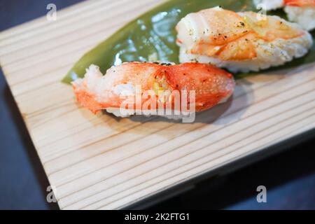 Taraba Sushi served on wooden tray.  Japanese Cuisine Buffet. Stock Photo