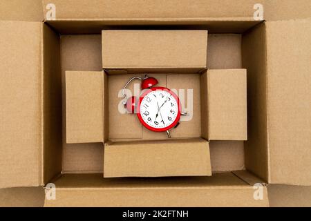 Retro red alarm clock in carton box Stock Photo
