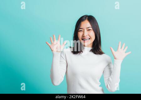 woman cheerful smiling makeup showing open hands Stock Photo