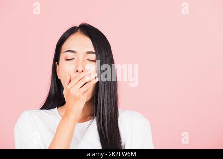 woman emotions tired and sleepy her yawning covering mouth open by hand Stock Photo