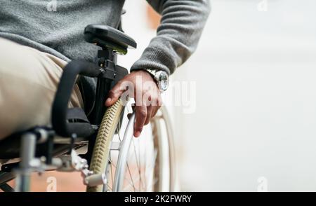 He can still get around. Cropped shot of an unrecognizable senior man sitting in his wheelchair at home. Stock Photo