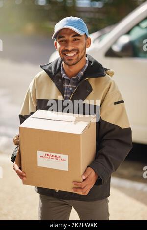 Ive got your delivery right here. Shot of a delivery man loading boxes into a vehicle. Stock Photo