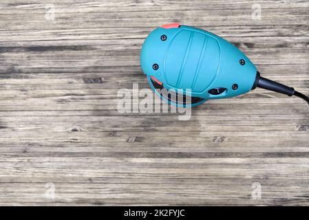 Top view of random orbital sander on wooden background with copy space Stock Photo