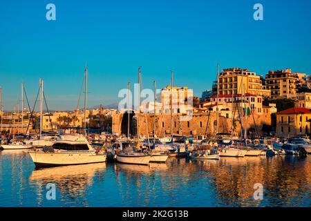 Venetian Fort in Heraklion and moored fishing boats, Crete Island, Greece Stock Photo
