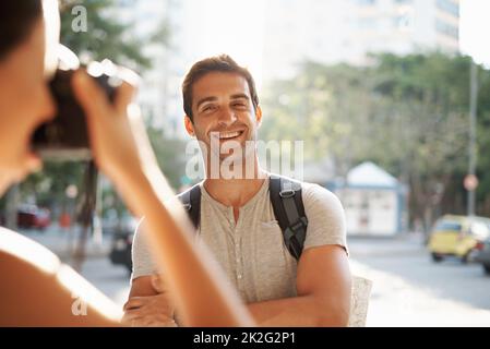 Thats one for the postcard. a young man posing for a photo while touring a foreign city. Stock Photo