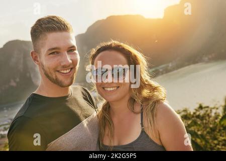 Summer lovin. Portrait of a happy young couple posing outside together. Stock Photo