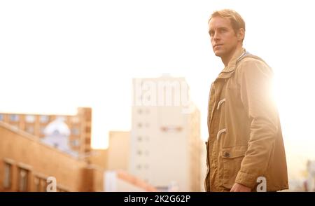 You dont know the city until youve seen it on foot. Cropped shot of a handsome man walking through a city. Stock Photo