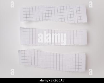 A set of white torn strips of checkered paper on a white background. Torn horizontal and different sized blank paper for notes, template Stock Photo