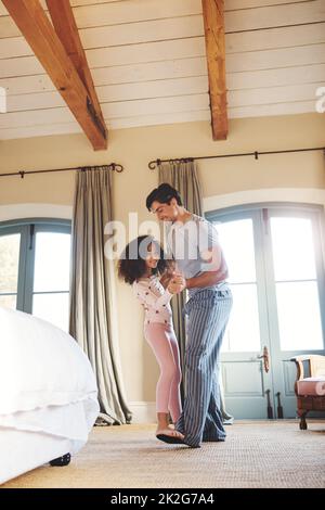 Dancing with his princess. Shot of a father and his little daughter dancing together at home. Stock Photo