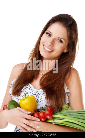 Healthy ingredients. Portrait of an attractive young woman holding a bunch of vegetables. Stock Photo