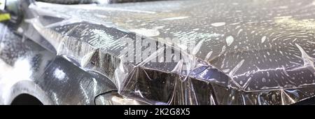 Car wrapping transparent vinyl film. Protection of the car hood from stone chips Stock Photo