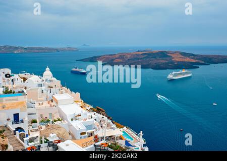 View of Fira town on Santorini island with cruise ships in sea Stock Photo