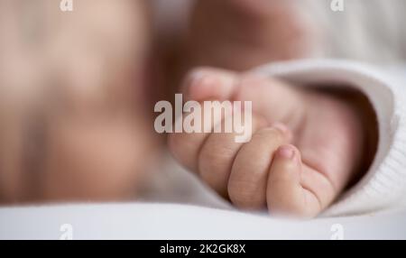 He fell asleep so soundly. Closeup shot of a babys hand while asleep at home. Stock Photo