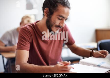 Working hard for good grades. young university students during class. Stock Photo