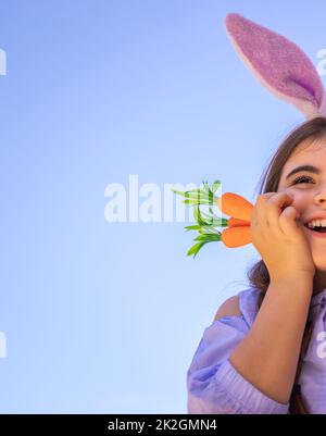 Happy easter. Cheerful little girl in a pink dress with polka dots on a ...