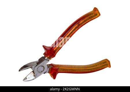 Closeup of an old rusty pair of cutting pliers or side cutters for cutting wire with red plastic handles isolated on white background. Clipping path. Electrician's tool. Stock Photo