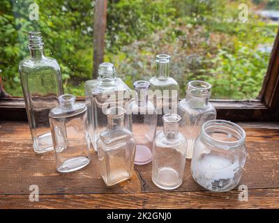 Angelsberg, Sweden - May 28, 2022: A shelf with different forms of glass bottles Stock Photo