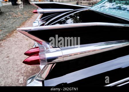 Tail fin of black painted American antique road cruiser Stock Photo