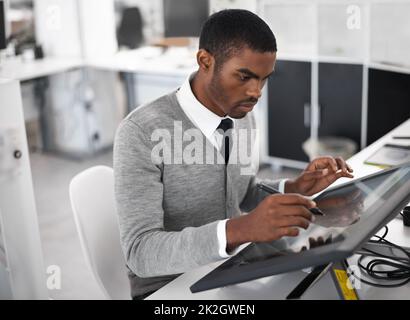 Smart technology makes everything easier. A young man working on a large touchscreen. Stock Photo