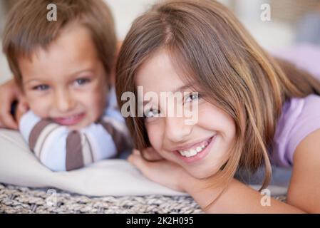 No rivalry here. Portrait of two young siblings hanging out together. Stock Photo