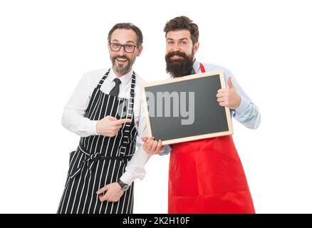 Hiring restaurant staff. Men bearded informing. Men bearded bartender in apron hold blank chalkboard. Bartender with blackboard advertisement. Hipster Stock Photo